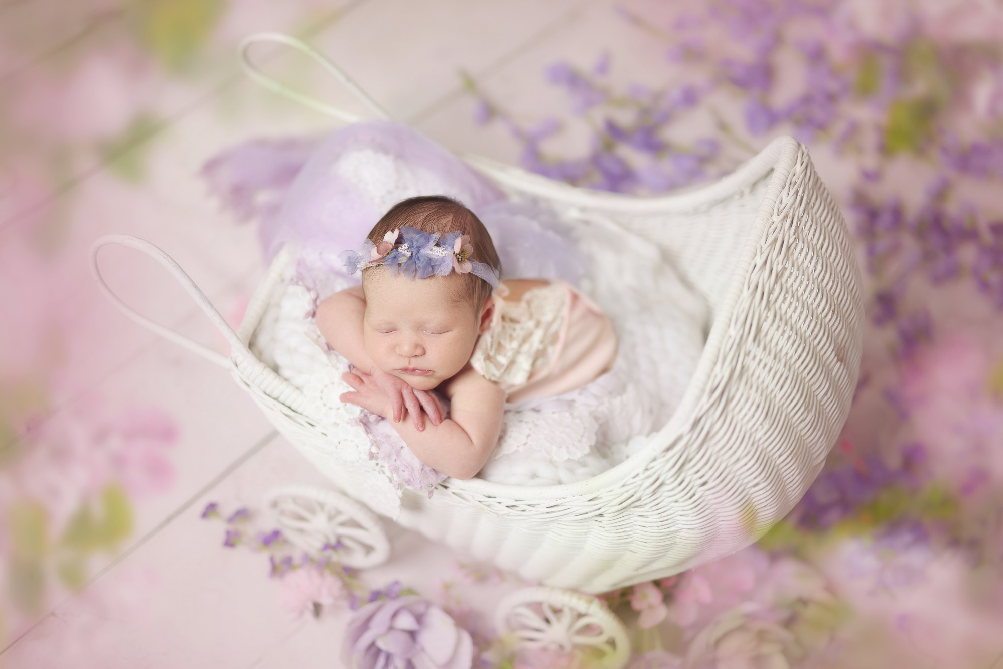 Newborn girl photography Columbus OH – baby in pink outfit with purple flower