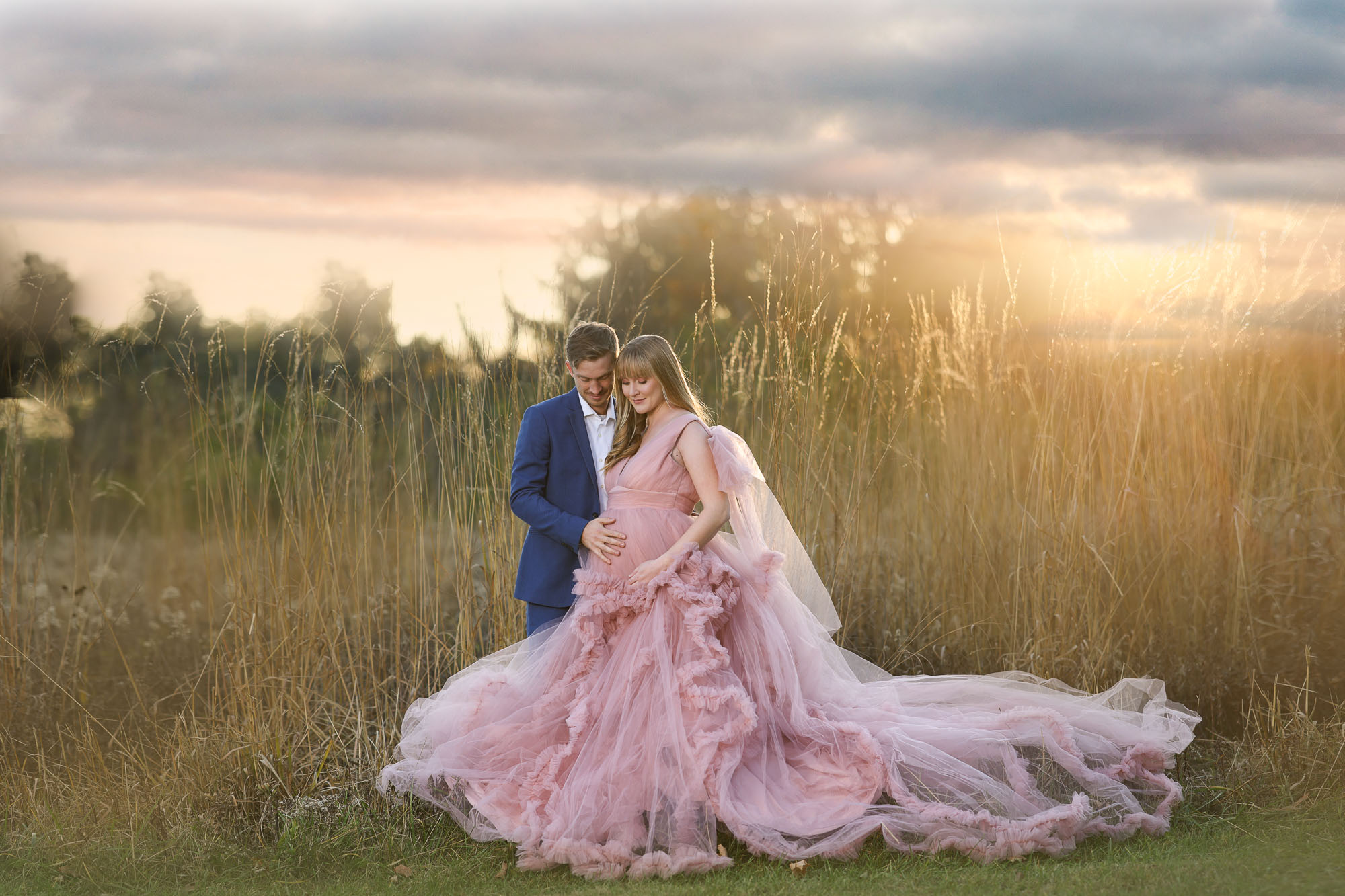 outdoor maternity photography Columbus OH with mom in flowing gown at sunset