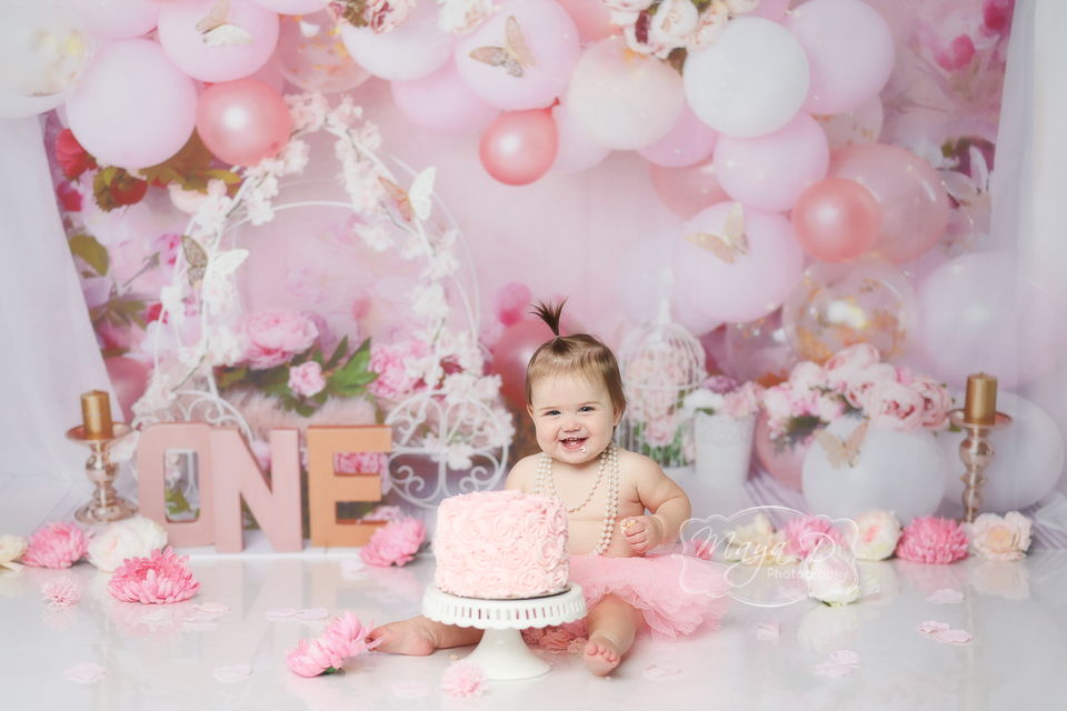 smash cake portrait with pink florals, butterfly and balloons. Pink, white gold color.