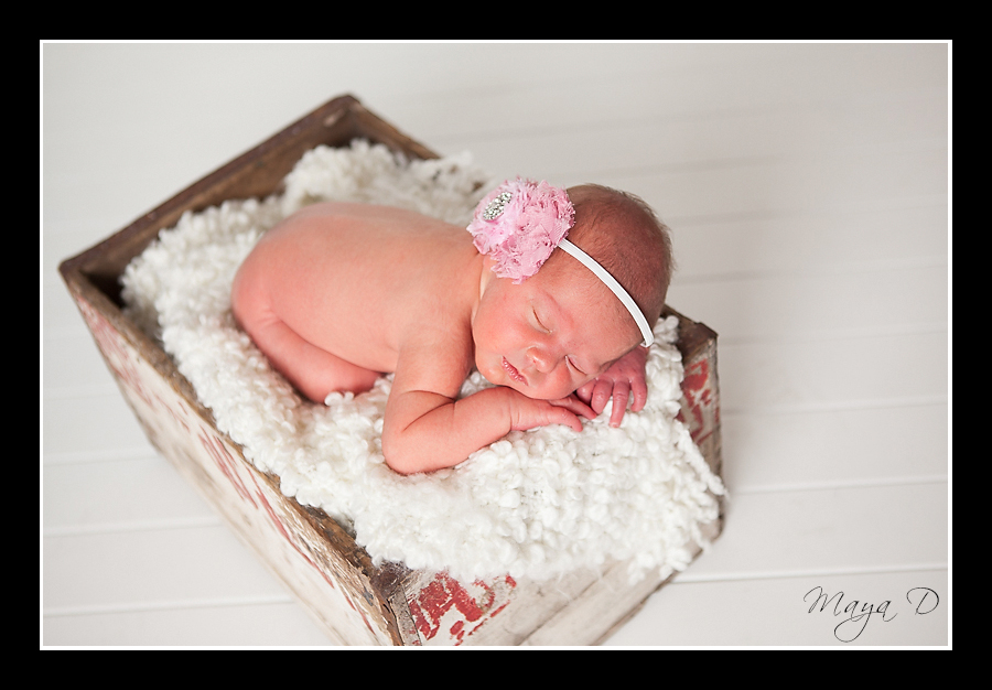 newborn in white crate