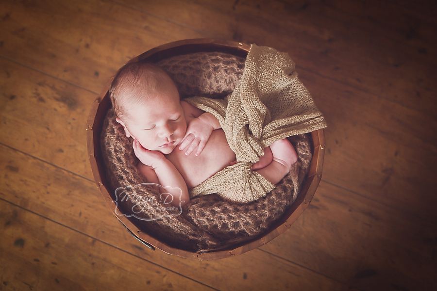 baby sleeping in a bowl