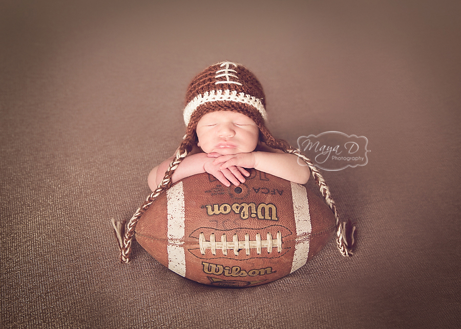 newborn boy with football hat